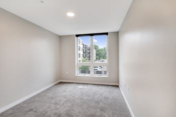 an empty living room with a large window